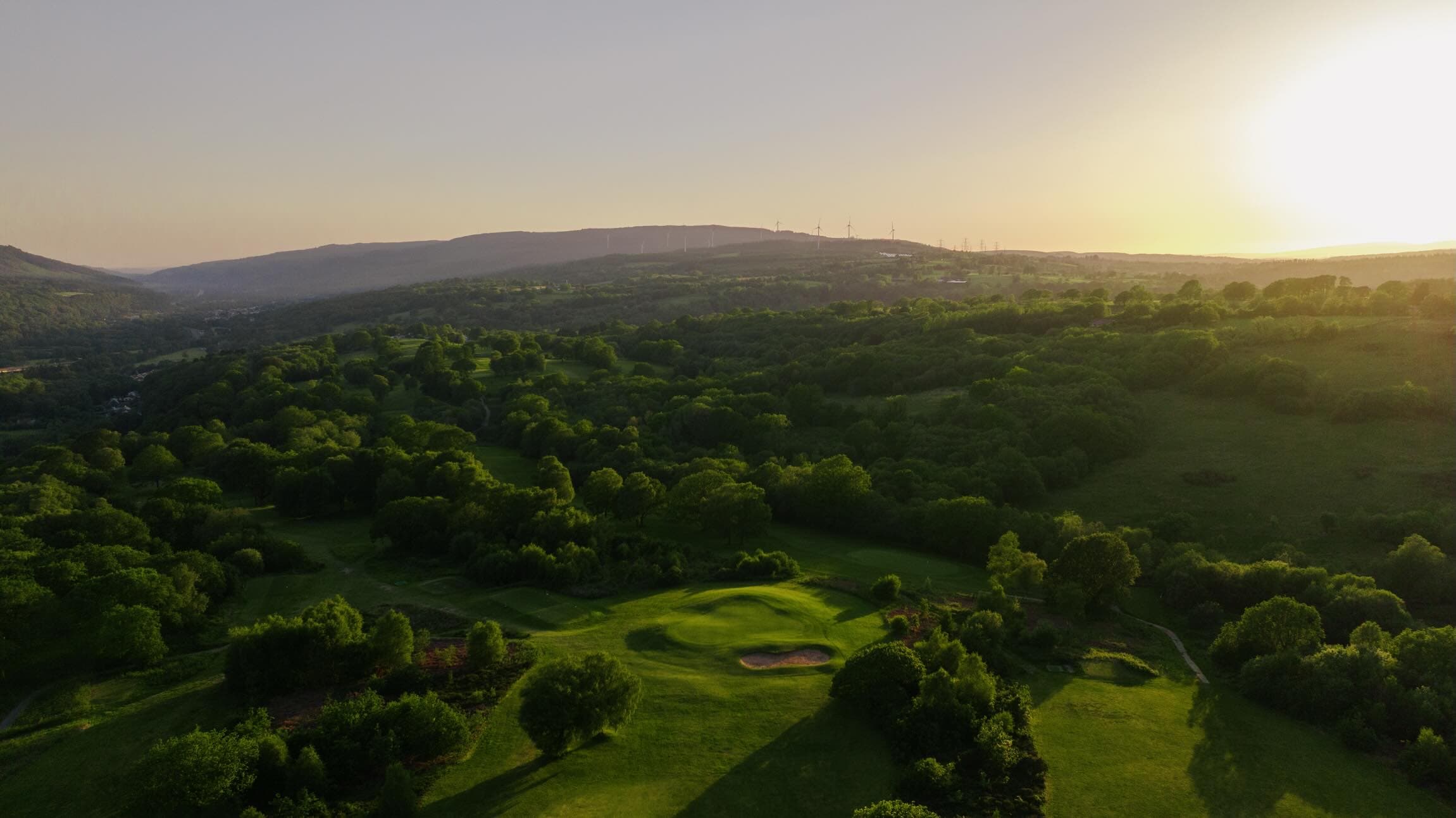 Glynneath Golf Club from the air at sunset, looking across the Neath valley